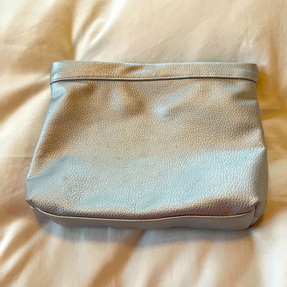 La Prairie zipped makeup bag in silver metallic.